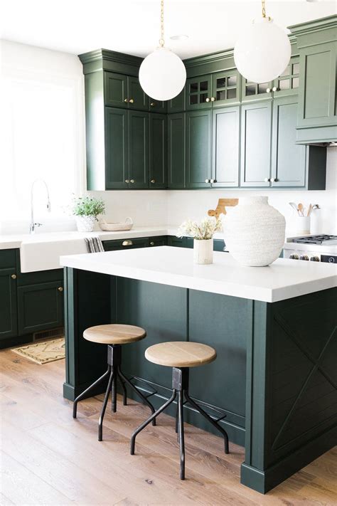 Dark navy blue kitchen cabinets paired amidst exposed, raw wood, is a distinctive look that gives you the freedom to create a modern or traditional look. Parade Home Reveal - Pt. 1 | Green kitchen cabinets ...