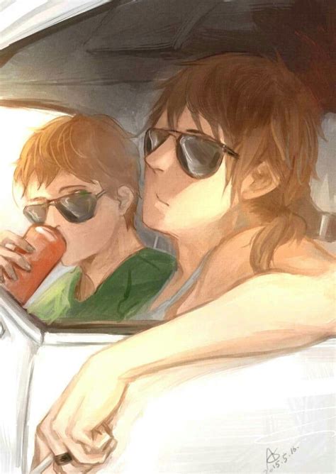 Two People Are Sitting In A Car Drinking From A Cup While Looking Out