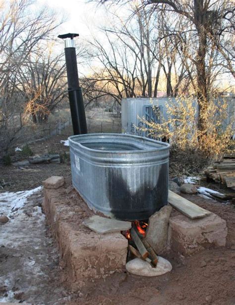 The stainless steel firebox inside also means. wood fired stock tank hot tub on 1/4 size adobe block base ...