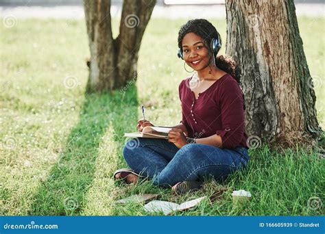 Sits On Grass Cheerful African American Woman In The Park At Summertime Stock Image Image Of