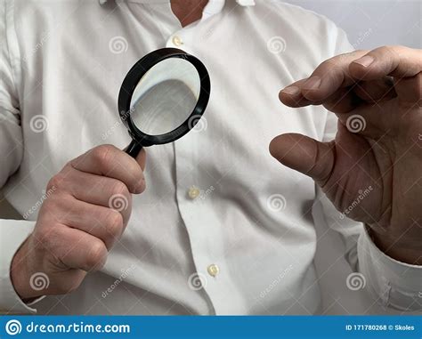 A Person Has A Magnifying Glass In His Hands A Man Holds A Magnifier