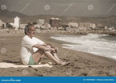 Senior Pensioner Sitting Relaxed On The Beach Retired Old Man On His