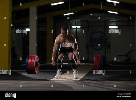 Professional Athlete Bent Over The Barbell And Is Preparing To Lift A