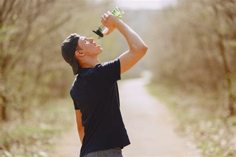 Thirsty Man Drinking Water During Training In Park · Free Stock Photo