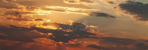 Panorama Of Golden Hour Orange Sky With Clouds And The Yellow Sun