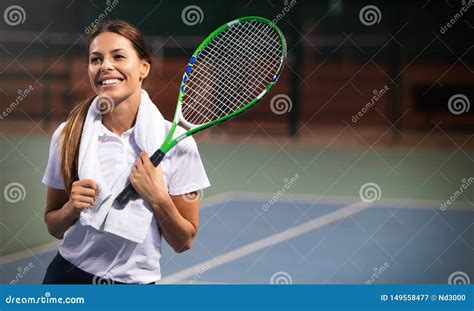 Woman Tennis Player Smiling While Holding The Racket During Tennis
