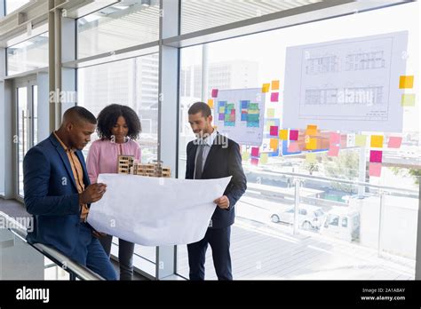 Three Young Architects Working Together Stock Photo Alamy
