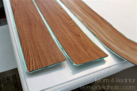 Just keep in mind that the joints in between the tiles aren't waterproof, making the vinyl tiles a poor choice for bathrooms and other areas with moisture. Remodelaholic | DIY Plank Backsplash Using Peel and Stick ...