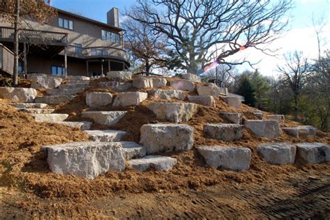 Most retaining walls are made from landscaping blocks that are held together in some way. Stonewall Inc. Boulder Landscaping