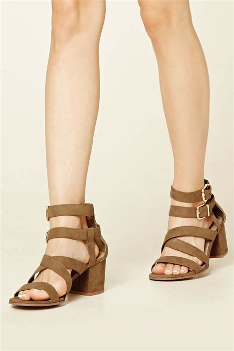 A Pair Of Faux Suede Sandals Featuring A Strappy Design An Open Toe A
