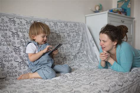 Pregnant Mom And Son Toddler Playing With Phone Lifestyle Rea Stock