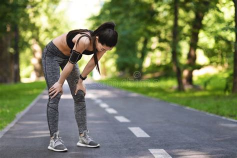 taking breath exhausted asian jogger girl resting after running in park stock image image of