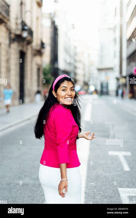 Latin Woman Walking Down The Street Turning Her Gaze Backwards And