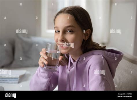 Portrait Of Smiling Teenage Girl Drinking Mineral Water Stock Photo Alamy