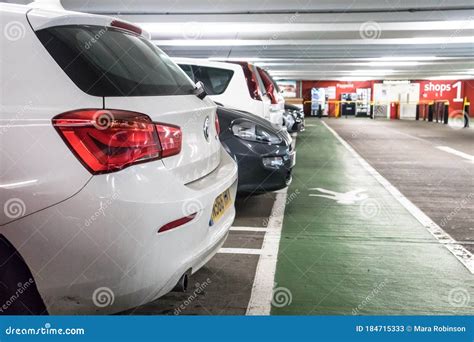 Row Of Parked Cars Inside A Covered Car Park With Pedestrian Walkway