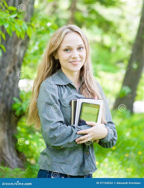 Portrait Of Beautiful Girl Holding Books In Their Hands Stock Photo