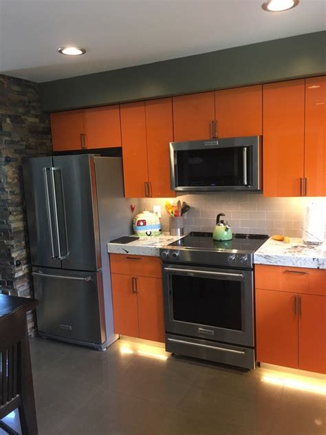 Shiny orange and white kitchen cabinets in contemporary style can be combined with all neutral colors and brown colors of natural wood. orange kitchen | Kitchen cabinet colors, Kitchen cabinet trends, Kitchen cabinets