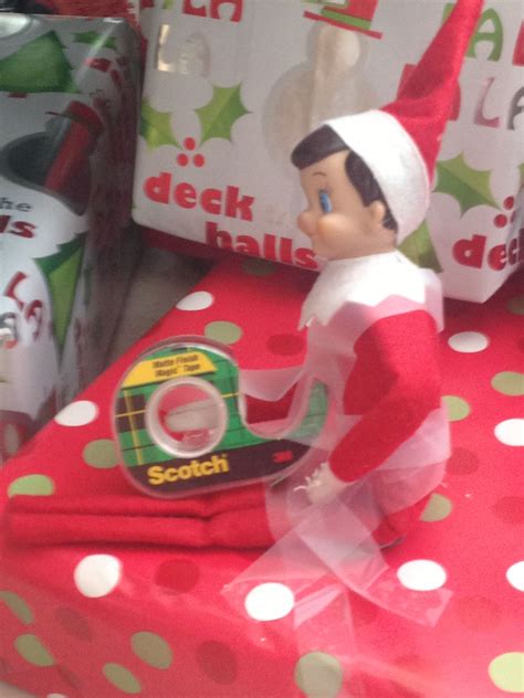 elf getting tangled in tape trying to wrap presents elf elf on the shelf holiday decor