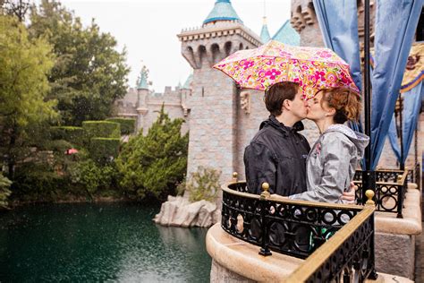 A Kiss In The Rain At Disneyland Disneyland Engagement Disney
