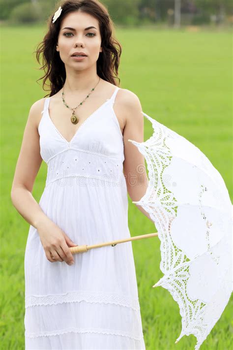 Beautiful Woman Posing With Umbrella In A Country Road