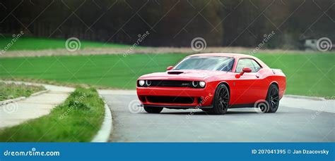 Red Dodge Challenger Srt Hellcat Standing On A Secluded Road By A Field