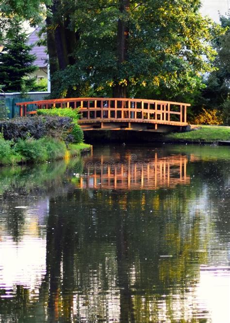 Photo Of Wooden Bridge Over The River In Summer Park Stock Image