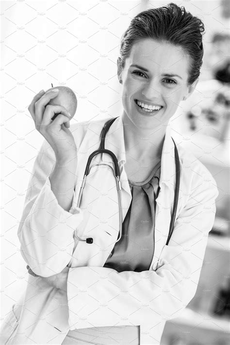 smiling medical doctor woman with apple containing woman doctor and healthy doctor medical