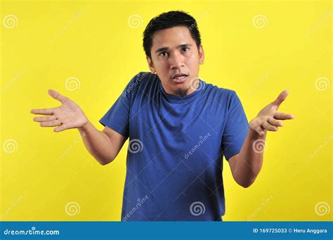 Young Man Asking Questions With Hands Raised Stock Image Image Of