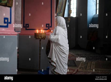 An Ethiopian Orthodox Worshiper Lights Candles Inside The Ethiopian