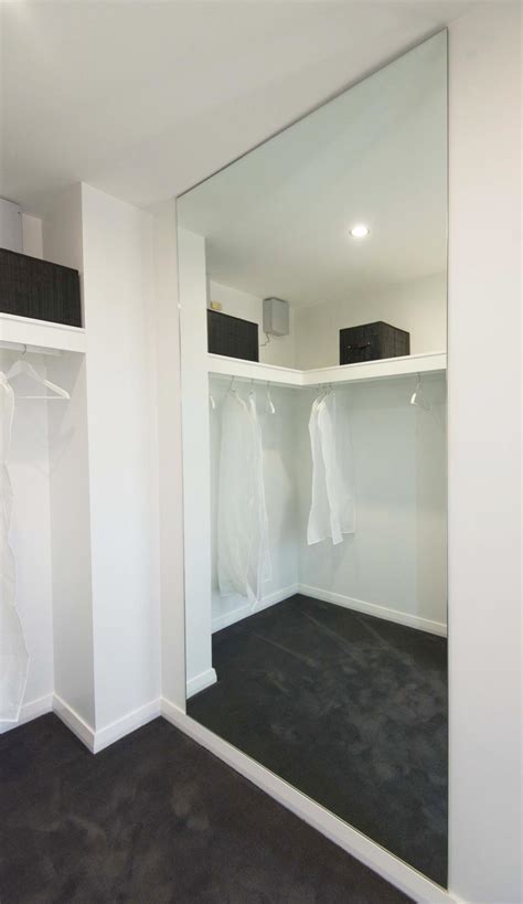 Movement along narrow wooden corridor. Custom Mirror Gallery | Stylish Wardrobes and Showerscreens