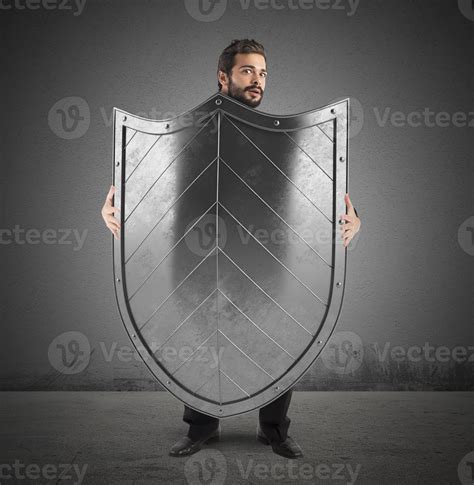 Frightened Businessman Hiding Behind A Shield 21203440 Stock Photo At