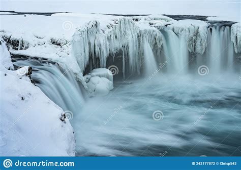 Godafoss Waterfall In Iceland Partially Frozen In Winter Long