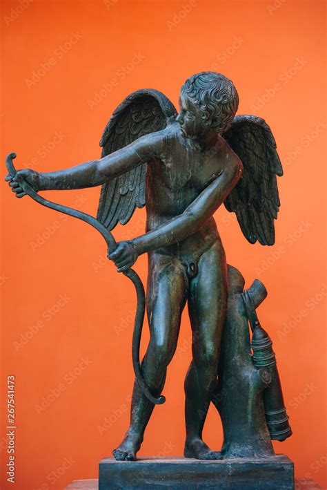 Outdoor Ancient Cupid Marble Sculpture From Public Park Isolated On Orange Background Beautiful