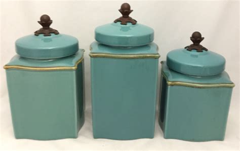 Three Blue Canisters With Gold Trim On Them