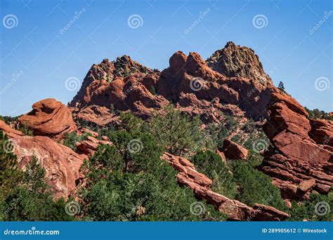 The Mountains Are Covered In Rocks And Bushes Outside Of Them Stock