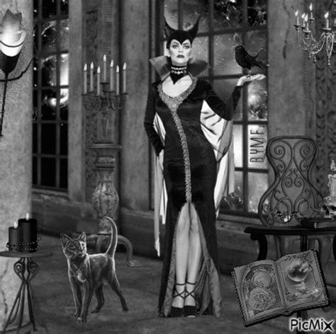 A Black And White Photo Of A Woman In Costume With Cats On Her Head Standing Next To A Cat