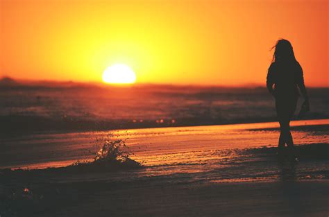 Free Photo Woman Standing On Beach During Sunset Backlit Beach