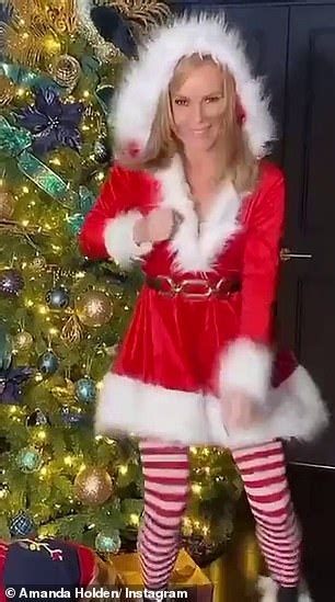 Amanda Holden Slips Into A Sexy Santa Costume And Dances Around Her Christmas Tree Daily Mail