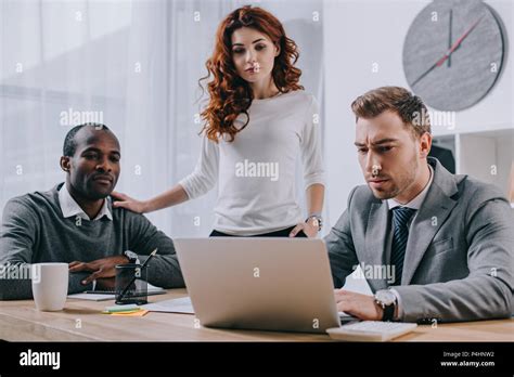 Estate Agent Working While Interracial Couple Watching Stock Photo Alamy