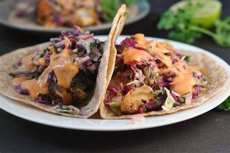 This easy fish taco recipe from delish.com will get on swimmingly with your guests. Blackened Fish Tacos with Cilantro Slaw and Sriracha Mayo ...
