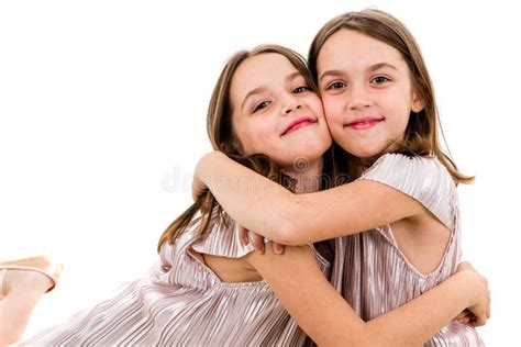 Identical Twin Girls Sisters Are Posing For The Camera Stock Image