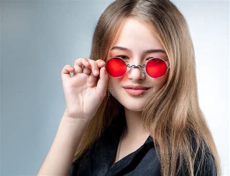 Beautiful Young Girl In Sunglasses With Mirror Glasses In The Studio