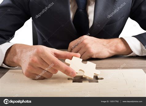 Businessman Completes A Puzzle — Stock Photo © Alphaspirit 132517762