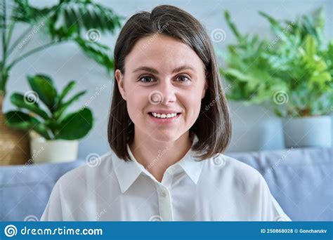 Headshot Young Smiling Woman Looking At Camera In Home Interior Stock