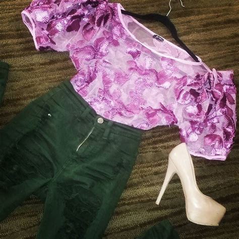 A Pink Top And Green Pants Are Laying On The Floor Next To A Pair Of