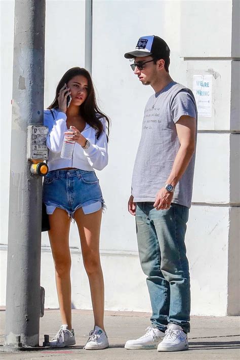 Madison Beer Wears A White Shirt And Denim Shorts As She Steps Out To