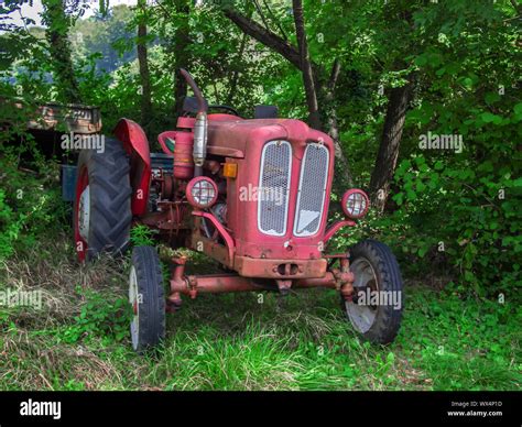 Vintage Red Tractor In Excellent Condition In A Wood Stock Photo Alamy