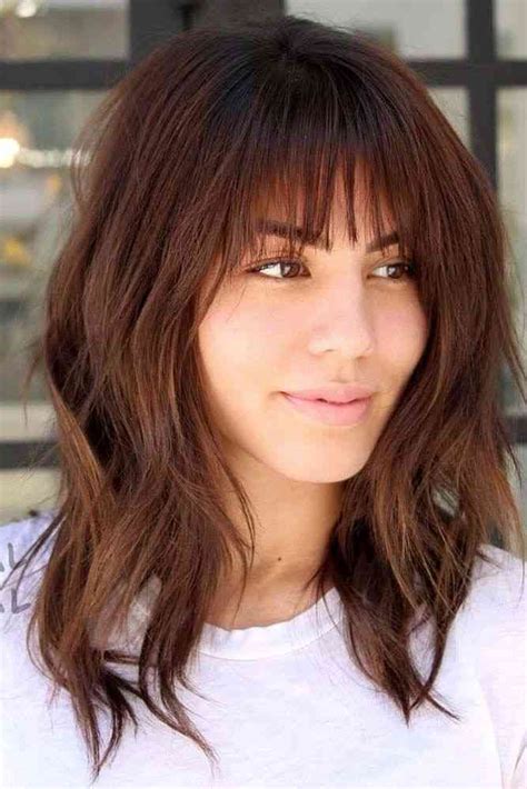 The hairstyle is then parted down the middle to achieve curtain bangs, which flow loose and freely to. 25 Latest Medium Hairstyles With Bangs For Women ...