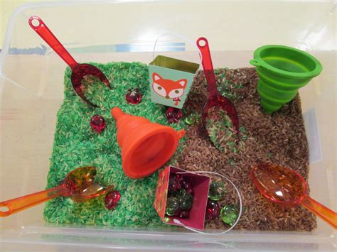Apple sensory table-apple scented rice, acrylic apples, scoops, pails
