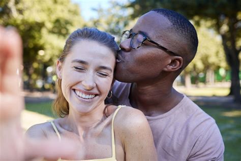 Premium Photo Love Kiss And Selfie With Interracial Couple At Park For Relax Social Media And